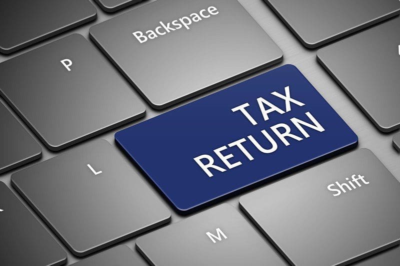 Keyboard wiht a blue button showing the words Tax Return