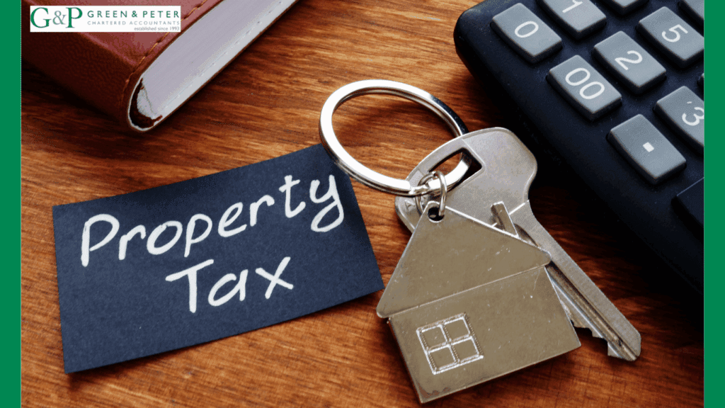 House shaped keyring with keys and tag saying rental property tax